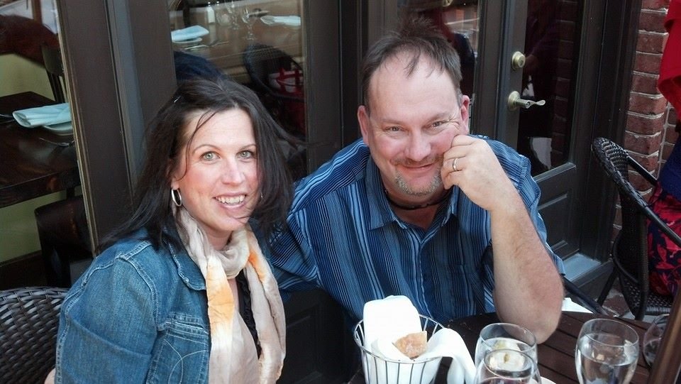 Happy couple enjoying an outdoor meal, representing wellness and balance in life.